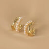 Gold-plated Pearl Accent Twist Hoop Earrings.