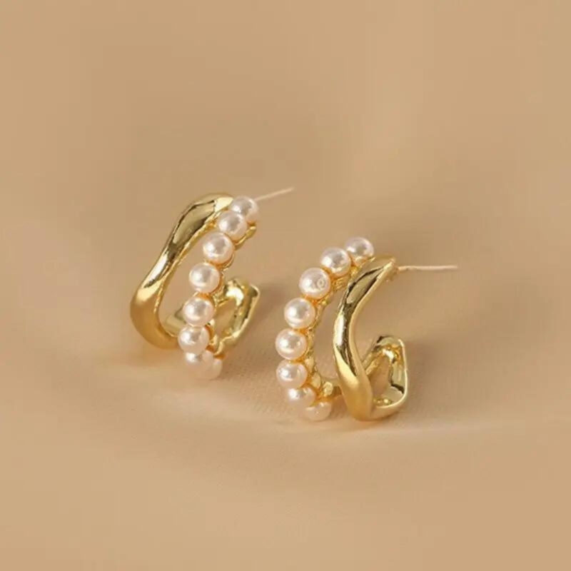 Gold-plated Pearl Accent Twist Hoop Earrings.