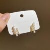 REINA Pearl and Rhinestone Bar Stud Earrings.