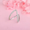 V-shaped ring adorned with cubic zirconia stones.