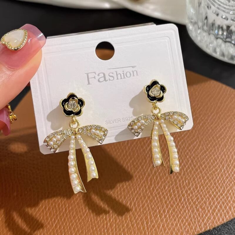 JJK 21 Fashion Luxury Camellia Pearl Stud Earrings or similar variations like Pearl Bow Dangle Earrings.
