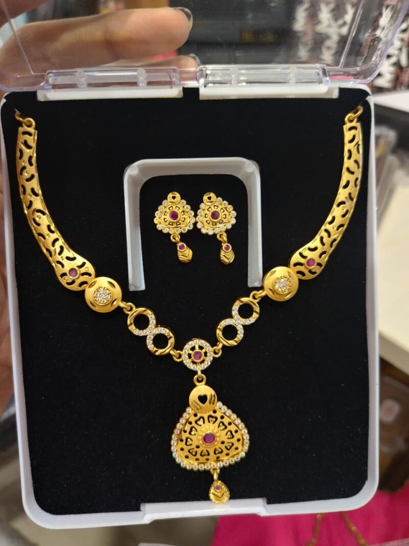 gold-plated necklace and earring set adorned with red stones