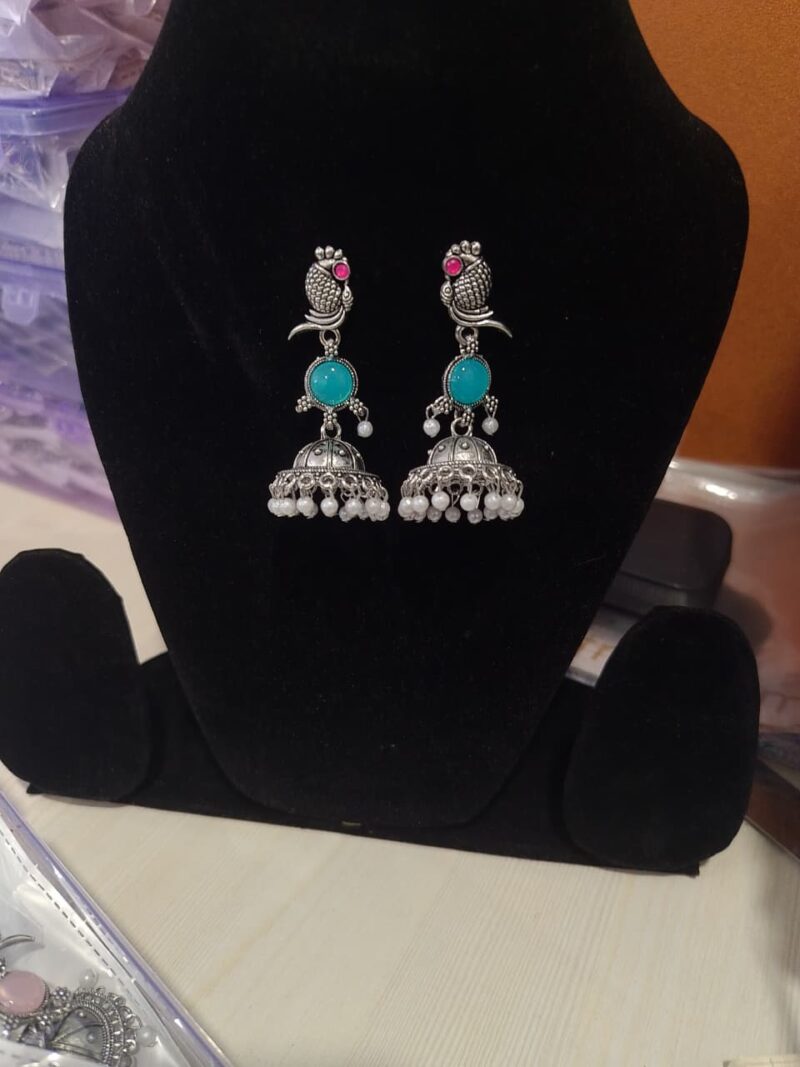 oxidized silver peacock jhumka earrings with turquoise stones and white pearl embellishments. - Image 2