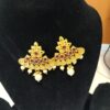 This is a pair of traditional Indian earrings, often referred to as jhumkas or chandbalis